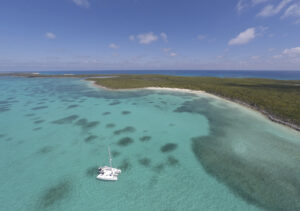 boat anchored off a beach in the bahamas